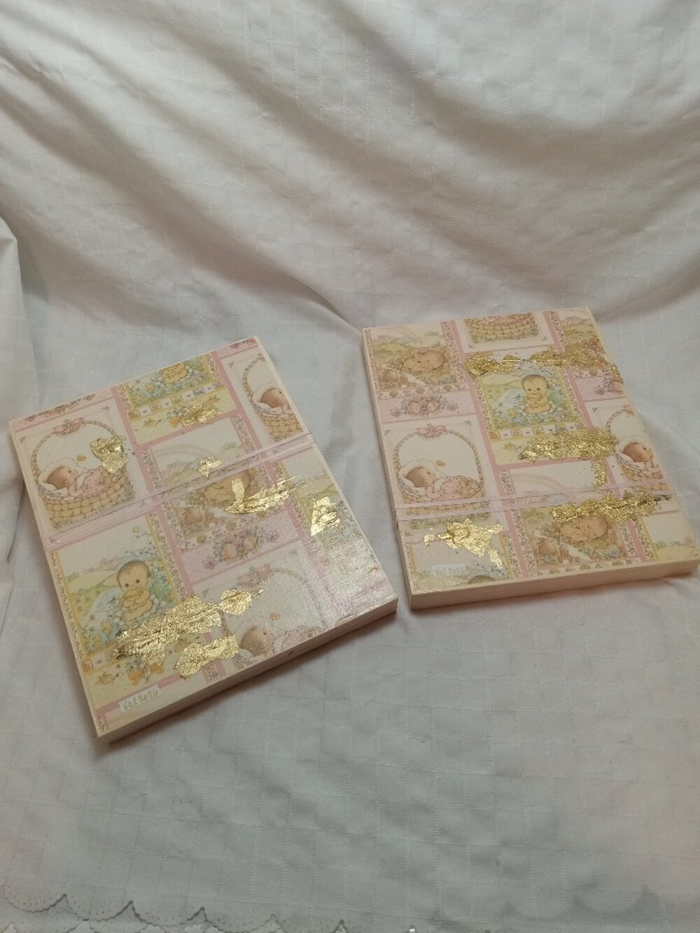 A set of delicate wooden frames for a baby's room with vintage wrapping paper